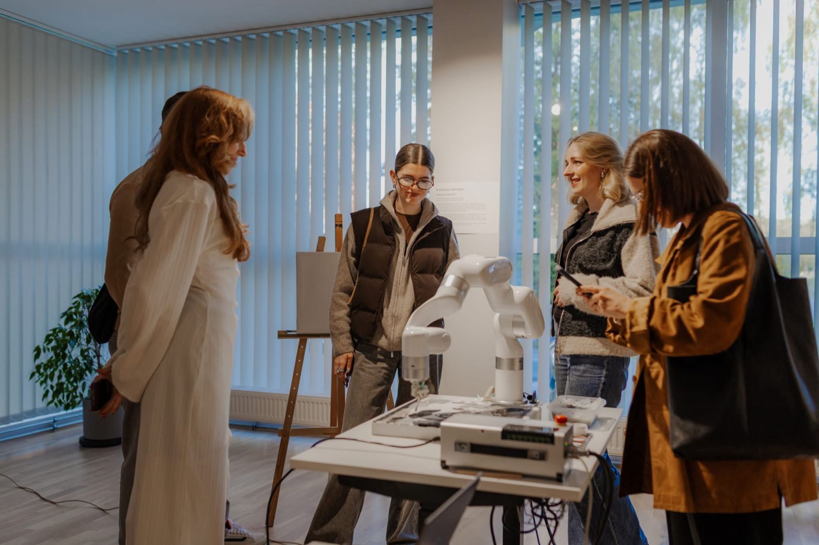 Visitors gathered around the robotic arm during the exhibition